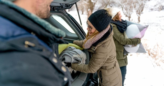 Woman taking stuff from car trunk